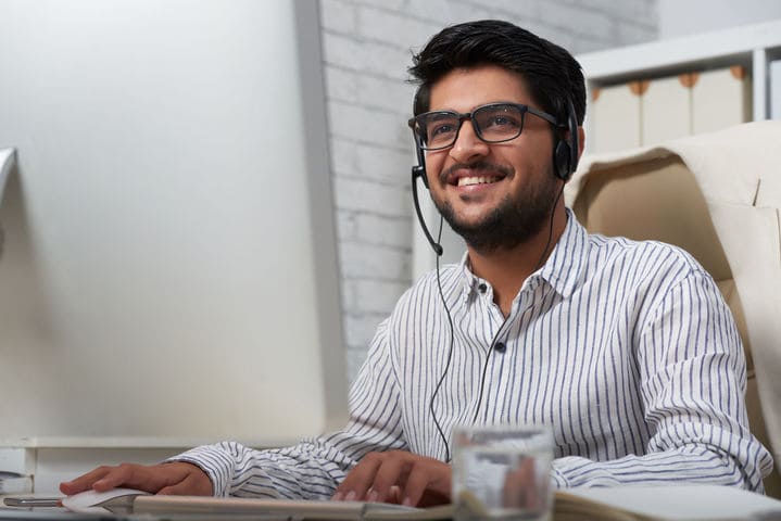 InfoCabs support advisor wearing a headset at his desk